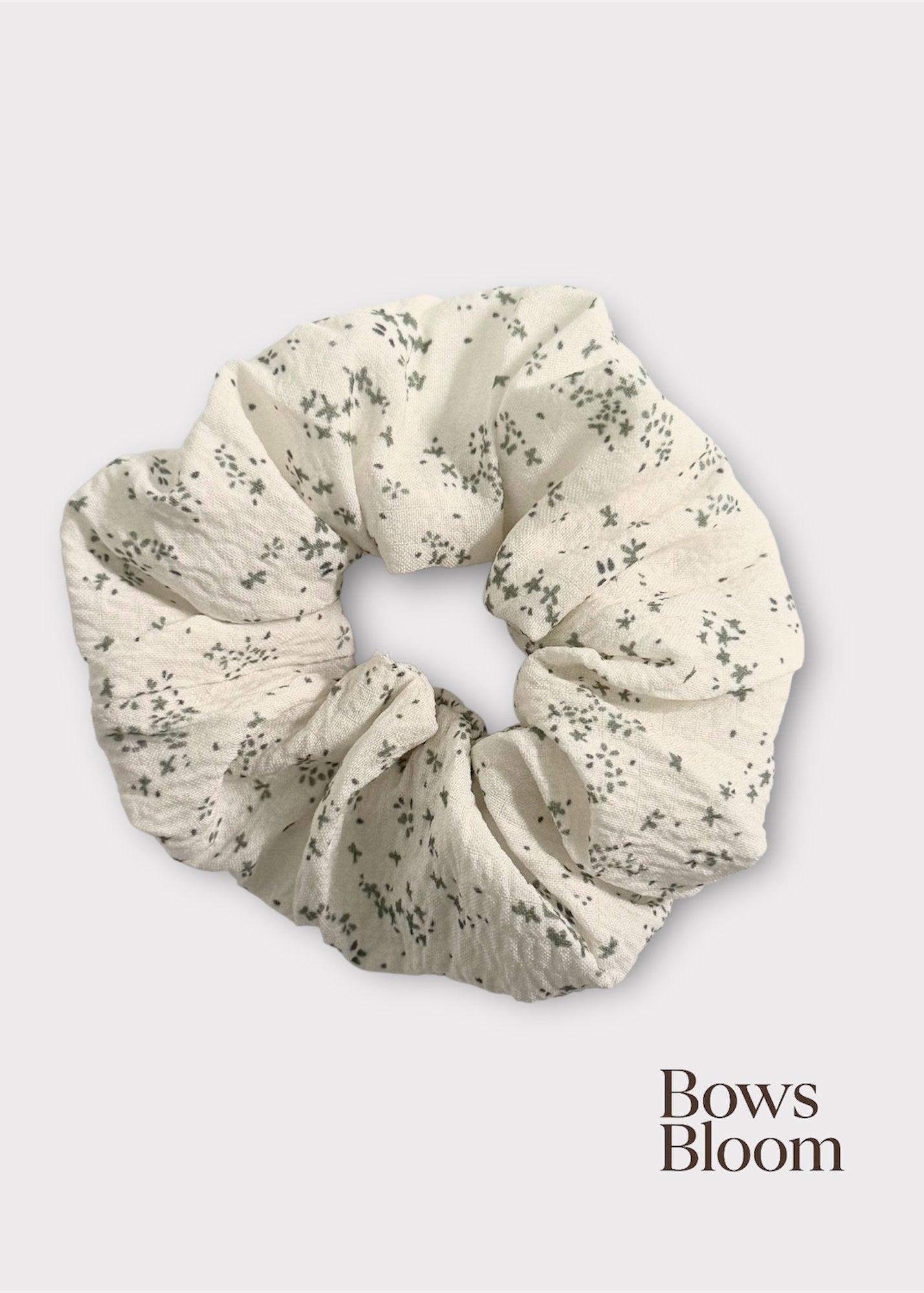 Floral patterned scrunchie on a white background with 'Bows Bloom' branding.