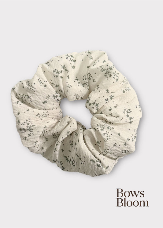 Floral patterned scrunchie on a white background with 'Bows Bloom' branding.