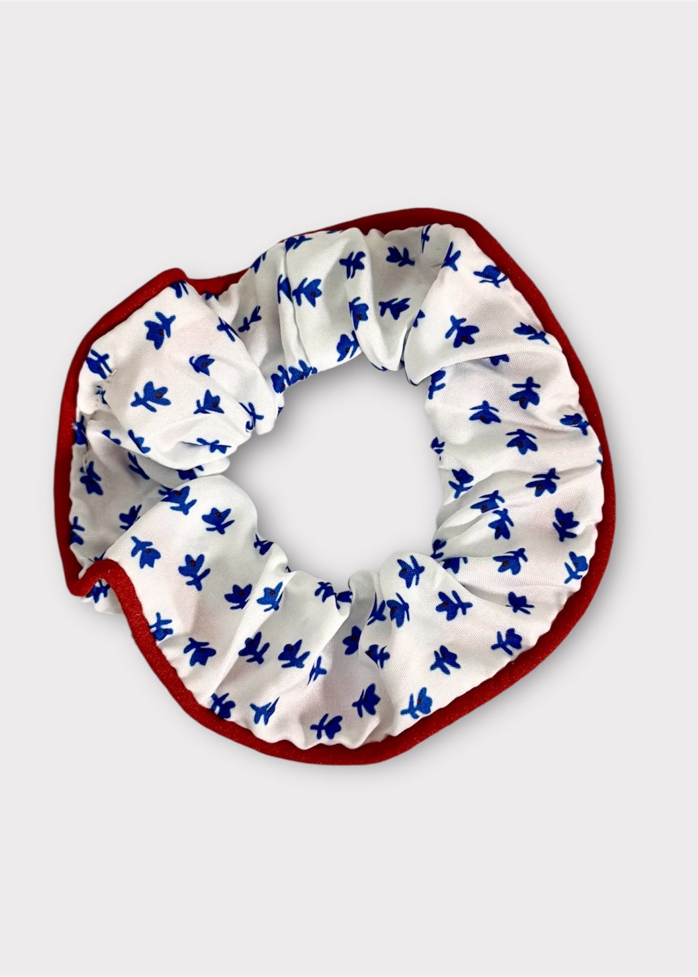 Scrunchie with blue floral pattern on a white background