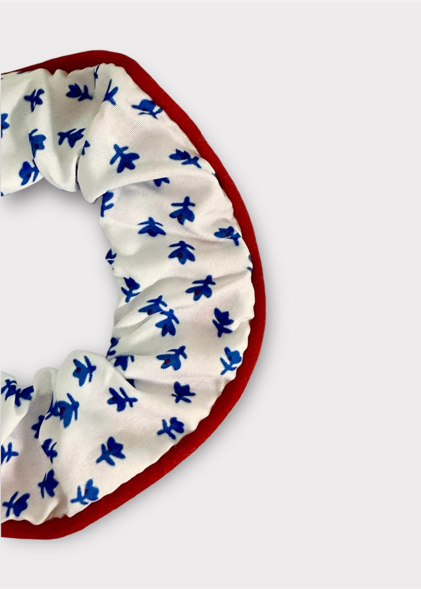 White headband with blue floral pattern on a white background